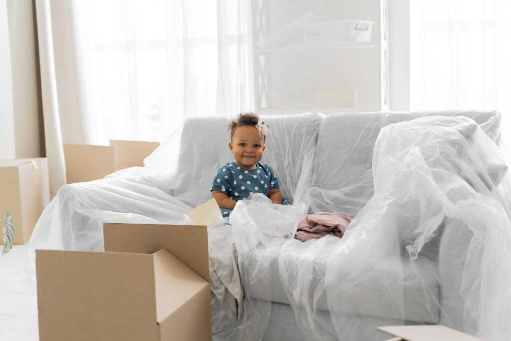 adorable-baby-girl-sitting-her-old-house-before-moving-out