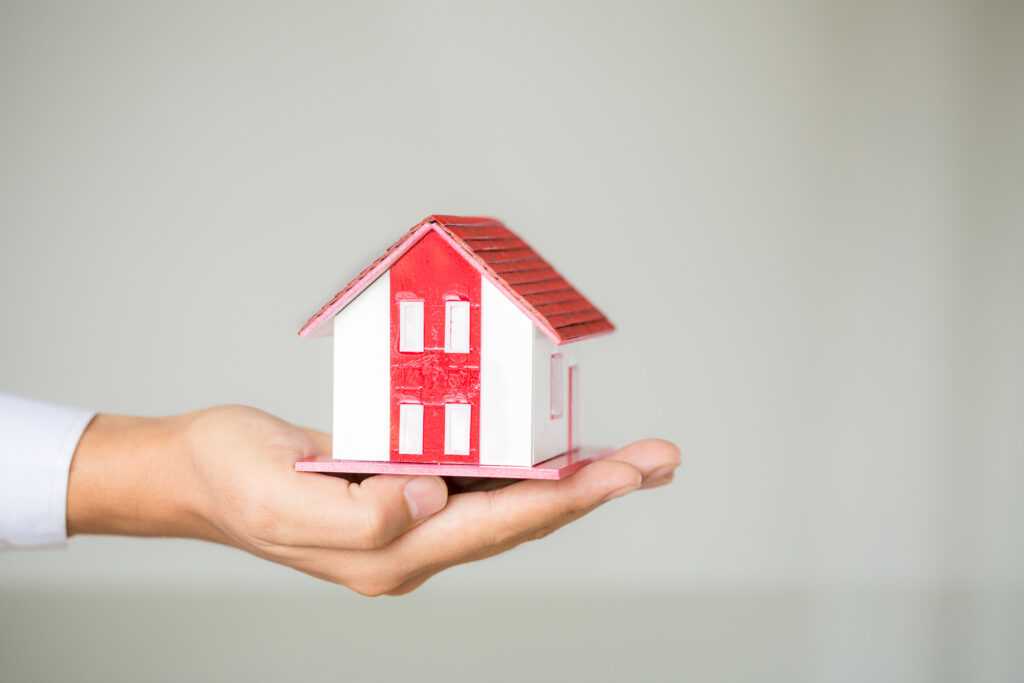businessman-holding-model-house